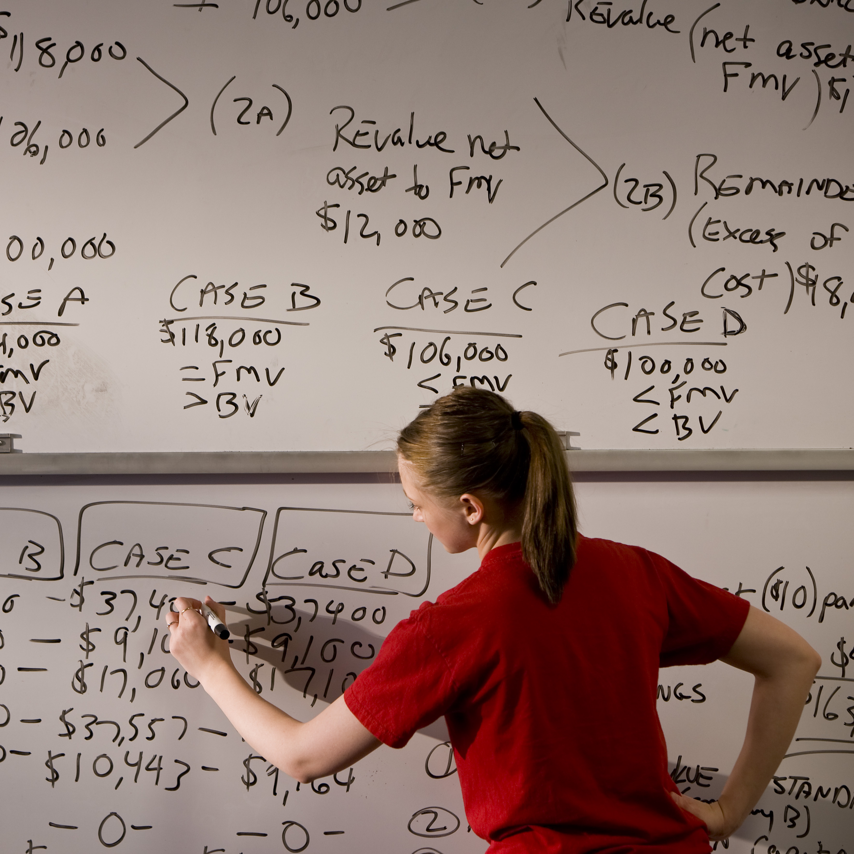 Student at whiteboard with formulas