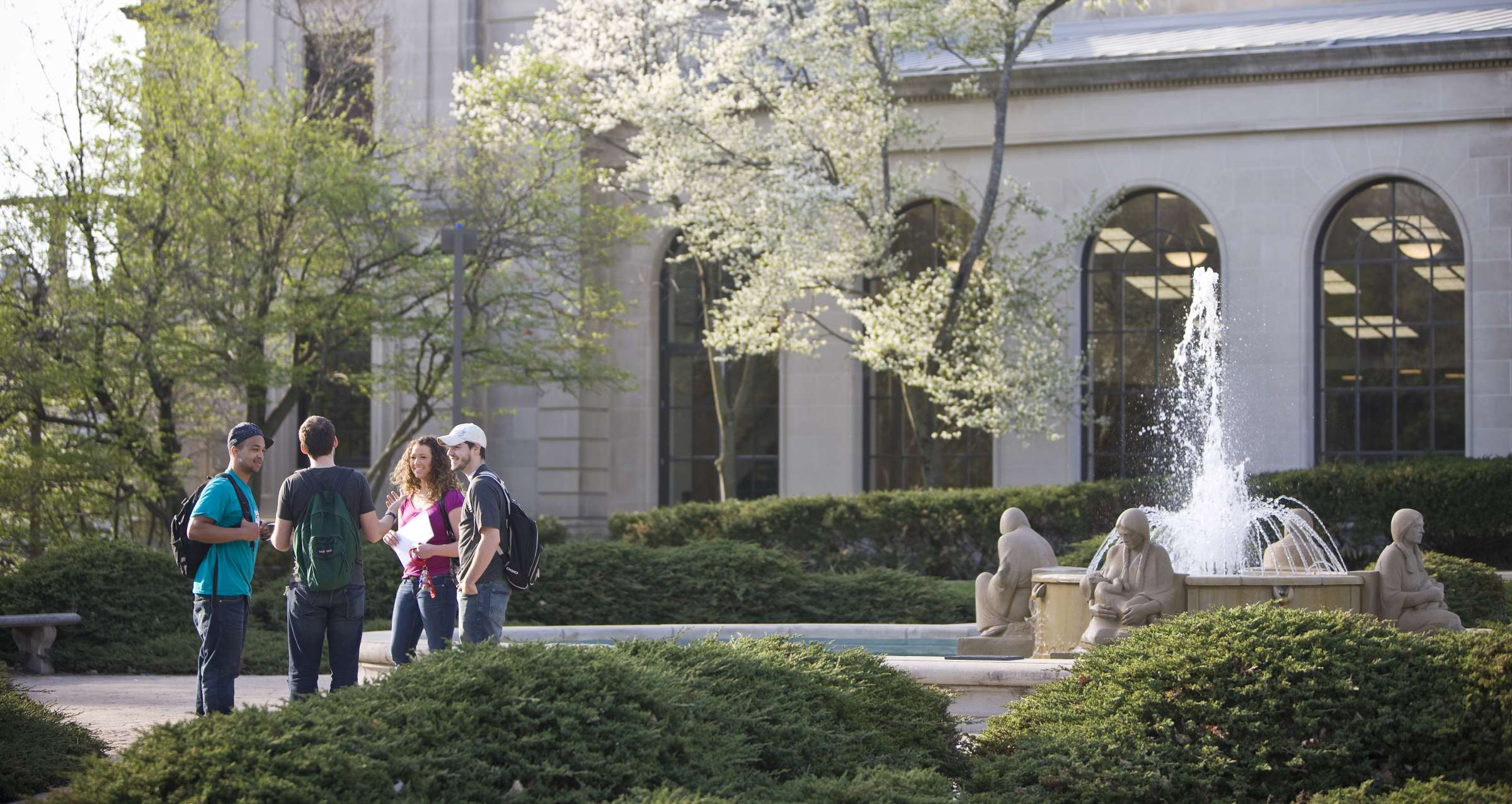 Students standing next to the Memorial Union fountain.